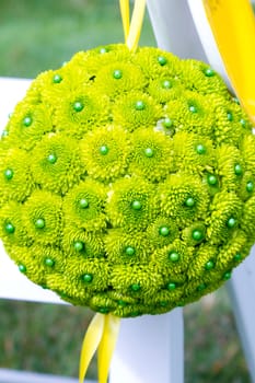 Flowers are placed together to create these unique green floral balls for wedding decor.