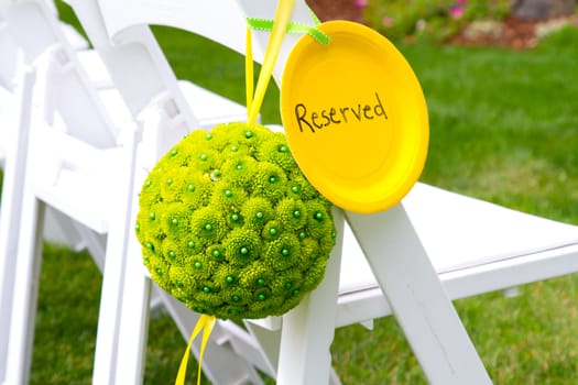 Flowers are placed together to create these unique green floral balls for wedding decor.