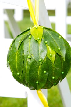 Flowers are placed together to create these unique green floral balls for wedding decor.