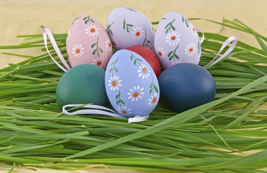 A collection of colorful easter eggs in grass nest