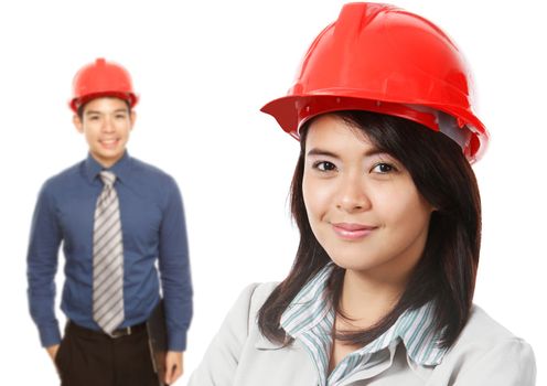 A man and a woman wearing hardhats (on white)