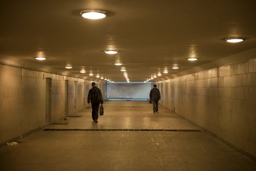 Two persons in the underground crosswalk, Moscow, Russia.