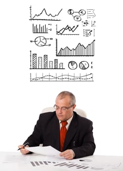 businessman sitting at desk with statistics and graphs, isolated on white