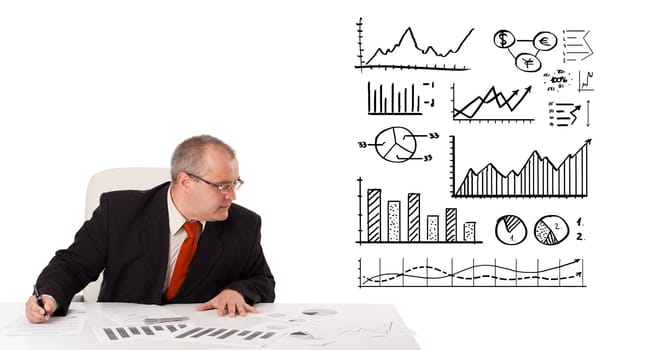 businessman sitting at desk with statistics and graphs, isolated on white