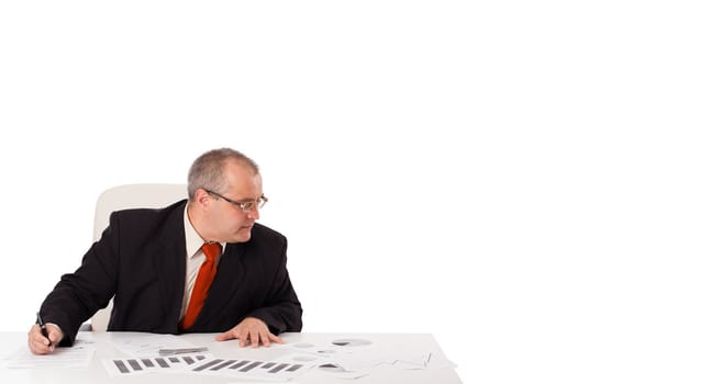 businessman sitting at desk with copy space, isolated on white