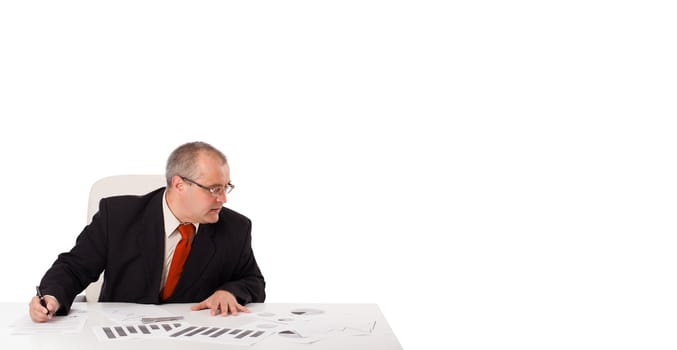 businessman sitting at desk with copy space, isolated on white