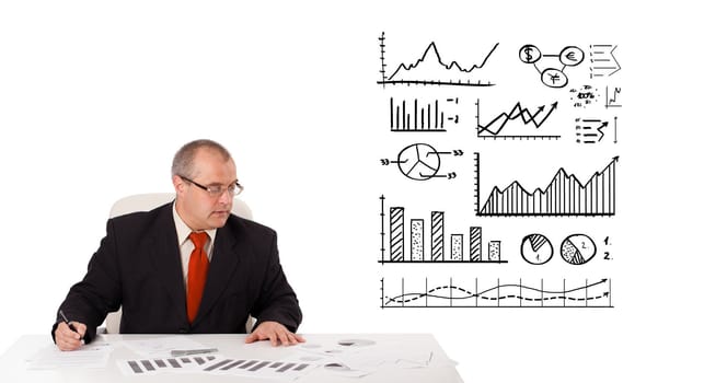 businessman sitting at desk with statistics and graphs, isolated on white