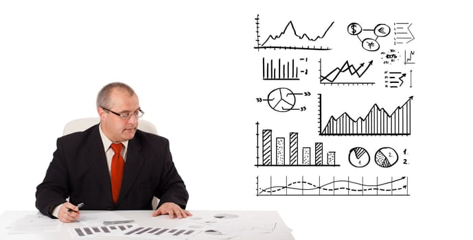 businessman sitting at desk with statistics and graphs, isolated on white