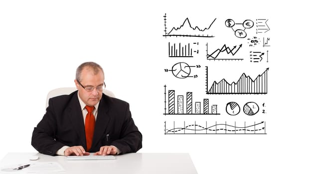 businessman sitting at desk with statistics and graphs, isolated on white