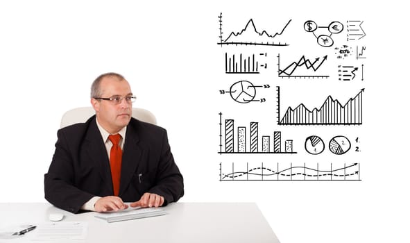 businessman sitting at desk with statistics and graphs, isolated on white