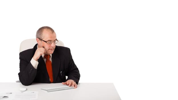 businessman sitting at desk with copy space, isolated on white