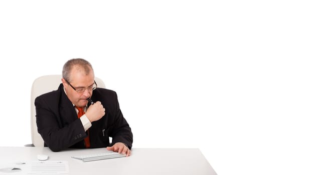 businessman sitting at desk with copy space, isolated on white