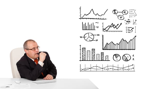 businessman sitting at desk with statistics and graphs, isolated on white