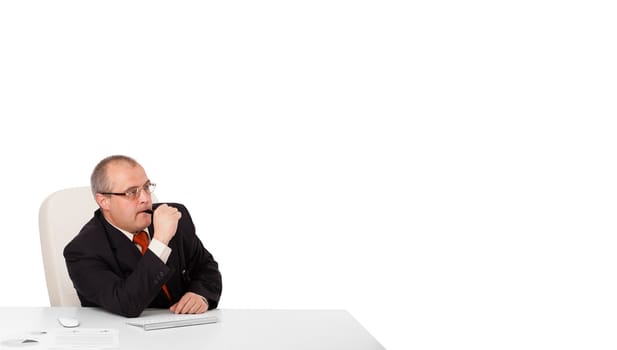 businessman sitting at desk with copy space, isolated on white