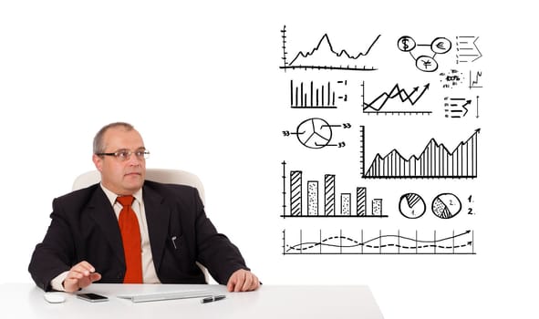 Businessman sitting at desk with diagrams and graphs, isolated on white