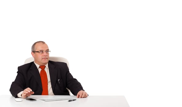 businessman sitting at desk with copy space, isolated on white