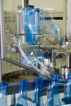 Plastic water bottles on conveyor or water bottling machine industry with motion blur