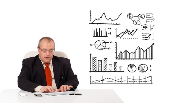 Businessman sitting at desk with diagrams and graphs, isolated on white