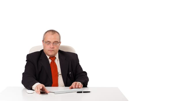 businessman sitting at desk and looking mobilephone with copyspace, isolated on white