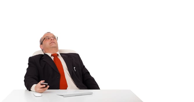 businessman sitting at desk and holding a mobilephone with copys pace, isolated on white