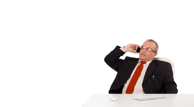 businessman sitting at desk and making phone call with copy space, isolated on white