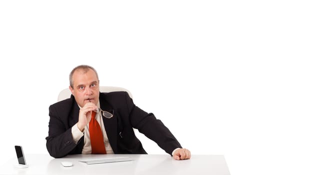 businessman sitting at desk with copy space, isolated on white