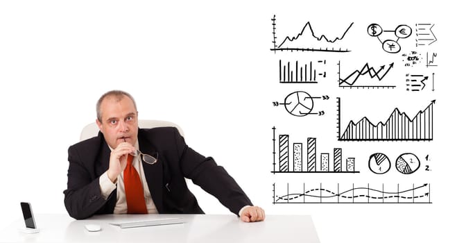 Businessman sitting at desk with diagrams and graphs, isolated on white