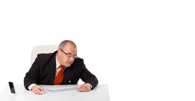 businessman sitting at desk with copy space, isolated on white