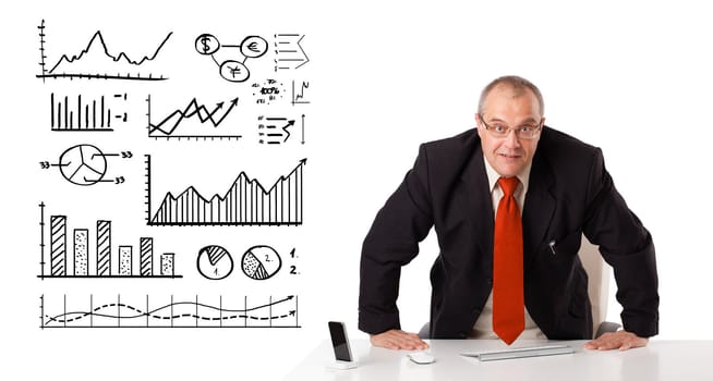 Businessman sitting at desk with diagrams and graphs, isolated on white