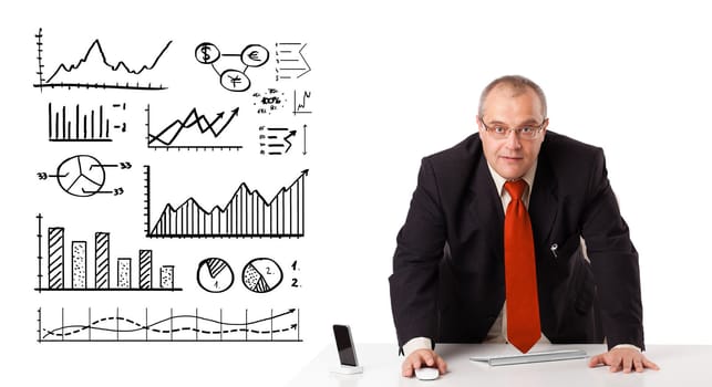 Businessman sitting at desk with diagrams and graphs, isolated on white