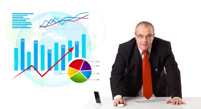 Businessman sitting at desk with statistics, isolated on white