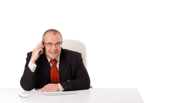 businessman sitting at desk and making phone call with copy space, isolated on white