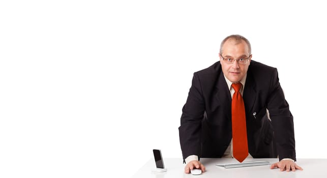 businessman sitting at desk with copy space, isolated on white