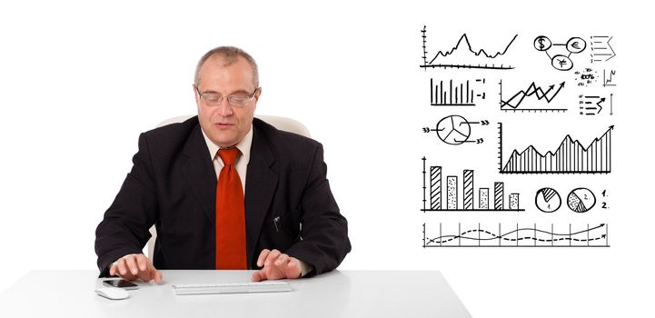 Businessman sitting at desk with diagrams and graphs, isolated on white