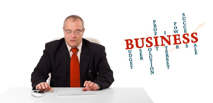 businessman sitting at desk and typing on keyboard with word cloud, isolated on white