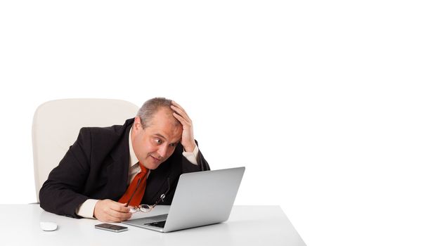 buisnessman sitting at desk and looking laptop with copy space, isolated on white