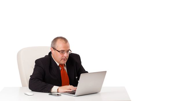 buisnessman sitting at desk and looking laptop with copy space, isolated on white