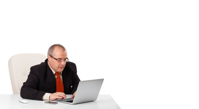 buisnessman sitting at desk and looking laptop with copy space, isolated on white