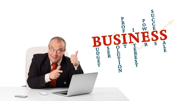bisinessman sitting at desk and looking laptop with business word cloud, isolated on white