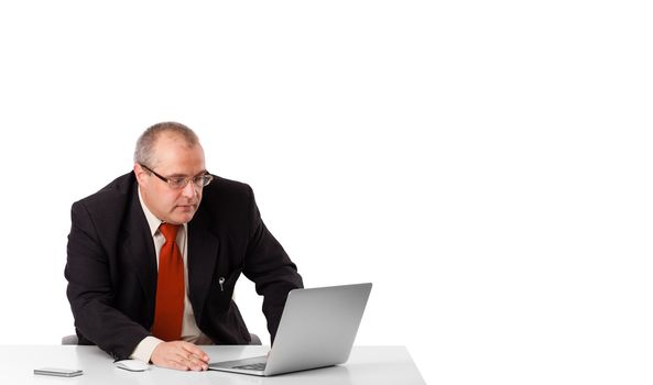 buisnessman sitting at desk and looking laptop with copy space, isolated on white