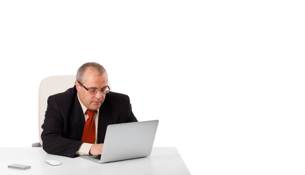 buisnessman sitting at desk and looking laptop with copy space, isolated on white