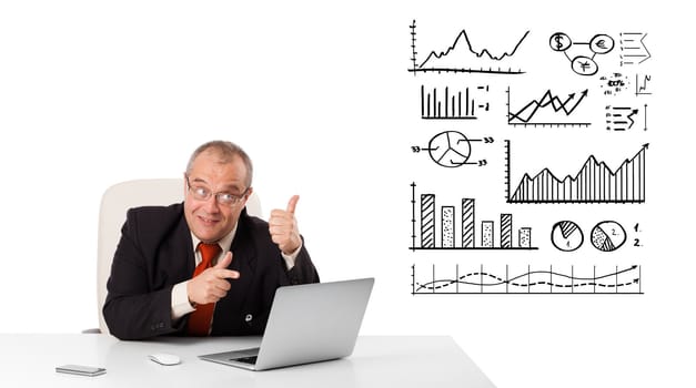 Businessman sitting at desk with diagrams and laptop, isolated on white