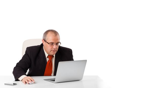 buisnessman sitting at desk and looking laptop with copy space, isolated on white