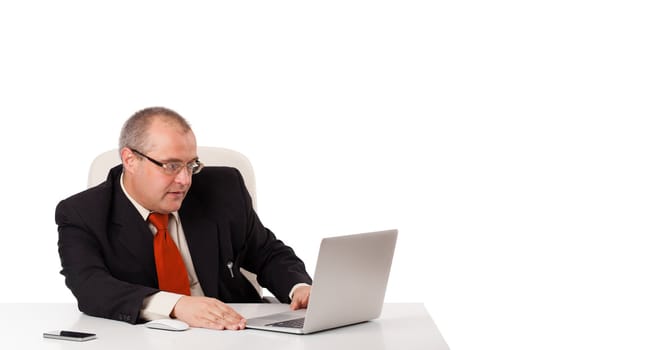 buisnessman sitting at desk and looking laptop with copy space, isolated on white