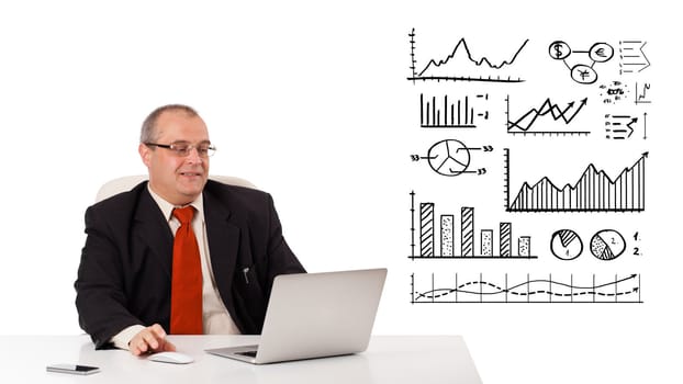 Businessman sitting at desk with diagrams and laptop, isolated on white