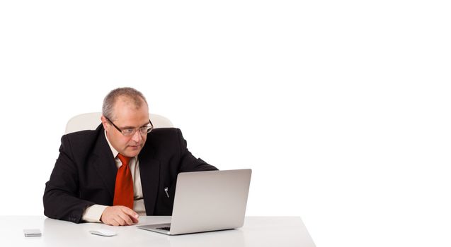 buisnessman sitting at desk and looking laptop with copy space, isolated on white