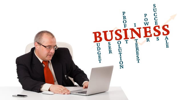bisinessman sitting at desk and looking laptop with business word cloud, isolated on white