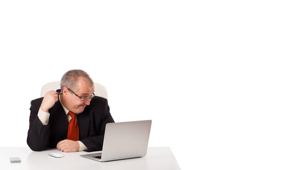 buisnessman sitting at desk and looking laptop with copy space, isolated on white