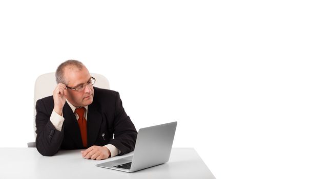 buisnessman sitting at desk and looking laptop with copy space, isolated on white