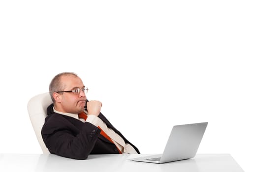 buisnessman sitting at desk and looking laptop with copy space, isolated on white